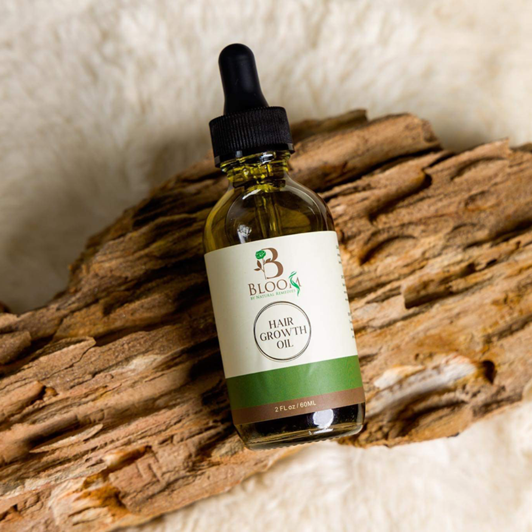 Organic Hair Growth Oil bottle showcasing clear labeling and natural ingredient list, positioned against a neutral backdrop to emphasize purity and organic quality.
